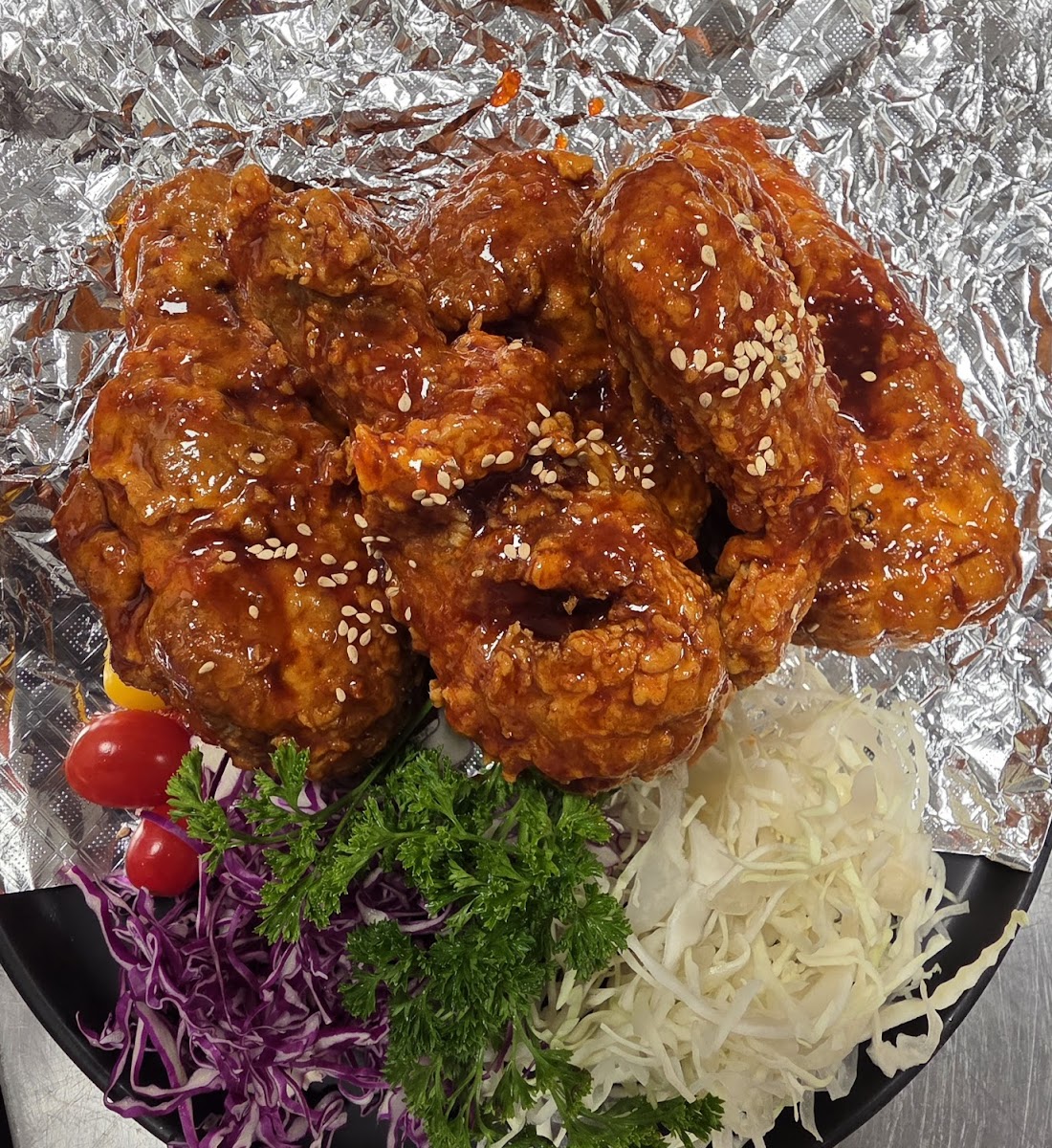 Korean fried chicken glazed with sweet-spicy sauce and sesame