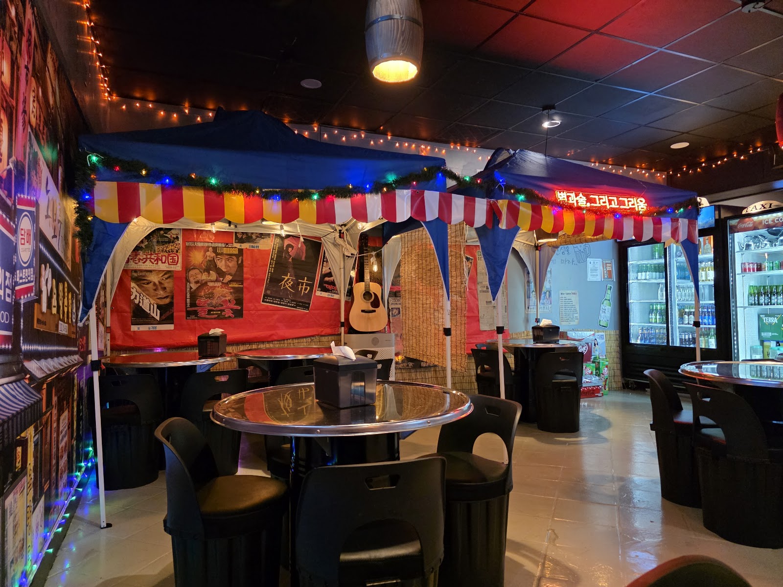 Byul Bam Pocha — indoor pojangmacha tents strung with lights, vintage posters, guitar and bar seating